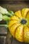 Yellow pumpkin on wooden table, clouse up