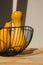 Yellow pumpkins in black deep bowl on a light background. Autumn composition. Halloween background