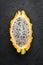 Yellow Pytahya on a black background. Fruit Dragon. Tropical Fruits. Top view.