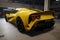 A yellow racing car with its exhaust system on full display in a garage. Speed drive concept. AI generation