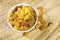 Yellow raisins or sultanas in a small white ceramic bowl