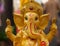 Yellow rasin Ganesh Elephant god statuecloseup focused on face
