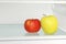 Yellow and red apple in domestic refrigerator.