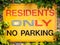 Yellow, Red and Black Sign Stating RESIDENTS ONLY NO PARKING