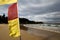 Yellow and red flags beach warning preventing lifesaving sign swimming between those flag