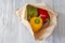 Yellow, red and green peppers in a brown paper bag.  Environmentally friendly packaging concept