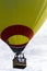 A yellow And Red Hot Air Balloon Lifting Off