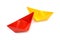 Yellow and red paper boats, origami. Colorful figures.