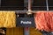 Yellow and red pasta hanging in a market