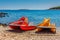 Yellow and red pedal catamaran boats with slide on a sea coast o