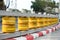 Yellow and red road railing barrier on the road.