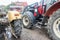 Yellow and red tractors  in the courtyard of a dairy farm.