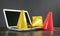 Yellow and red traffic cones on laptop keyboard
