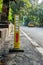 A yellow reflector on the side of a road India