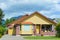 Yellow residential house with accurate lawn and concrete driveway to the garage