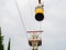 Yellow retro cable car lift on the background of the cloudy sky in the park