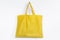 Yellow reusable fabric bag, on white background