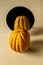 Yellow ribbed pumpkin standing in front of a round mirror