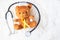 Yellow Ribbon on Bear doll with stethoscope on white background for supporting kid living and illness. September Childhood Cancer