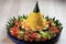 Yellow rice in a cone shape. In Indonesia called `Nasi Tumpeng