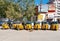 Yellow rickshaw taxis on a road in Puttaparthi village.