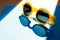 yellow rimmed sunglasses lie on a blue clean background