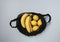 Yellow ripe bananas and lemons in black string mesh bag on light background, Zero waste concept, View from above