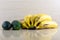 Yellow and ripe cucumbers Cucumis sativus. L and Bananas Musa spp on light background