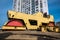 Yellow road roller works on construction site construction site