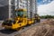 Yellow road roller works on construction site construction site