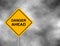 Yellow road sign as a warning of Danger Ahead. Background of dark grey sky with cumulus clouds and yellow banner. Vector illustrat