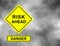 Yellow road sign as a warning of Danger Risk Ahead. Background