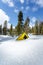 Yellow road sign covered by deep snow