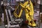 Yellow robotic arm equipped with a crate gripper.