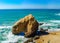 Yellow rocks and sand on portuguese coastline, vivid ocean water