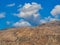 Yellow rocky hills and blue sky above