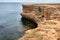 Yellow rocky seashore, cliff.