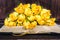 Yellow roses, book on wooden background. Vintage and retro style