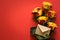 Yellow roses for valentines day arranged lying down on red paper background.