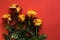 Yellow roses for valentines day arranged lying down on red paper background.