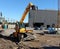 Yellow rotating telehandler at work in a construction site