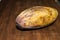 Yellow rotten mango fruit isolated on wood