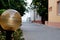 Yellow round lantern on the background of a gray path to the sea