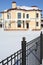 Yellow roundish two-storey new cottage and fence