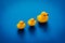 Yellow rubber duck mother leading her babies on blue background.