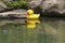 Yellow rubber duckie floating on water