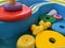 Yellow rubber ducks and rings floating in a play tray