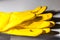 Yellow rubber gloves for safe cleaning, protection of the hands while performing tasks involving chemicals - Image