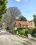 Yellow rural house with tile orange roof and garden with tree in city Cascais, Portugal