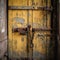 Yellow rusted door with chains